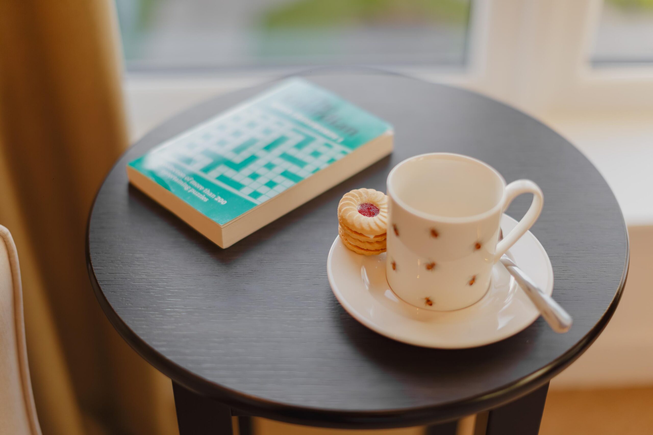 cup of tea and a book on a black sidetable