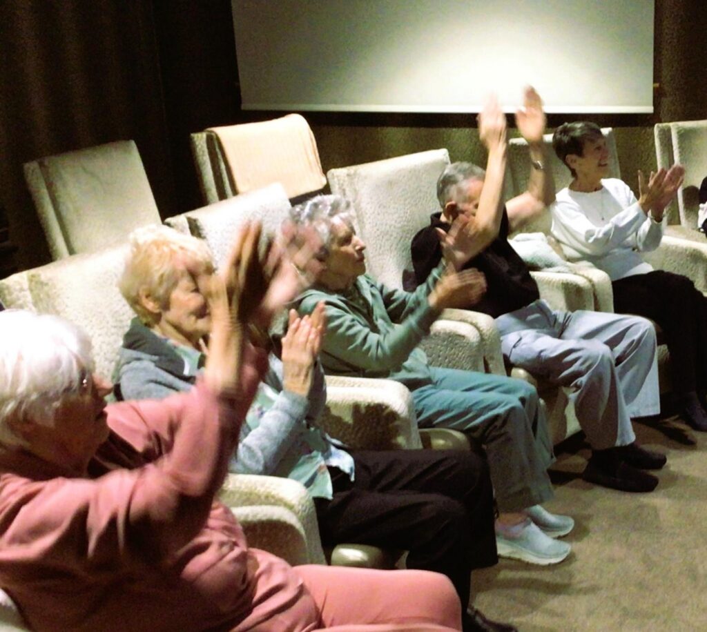 residents cheering in the cinema room