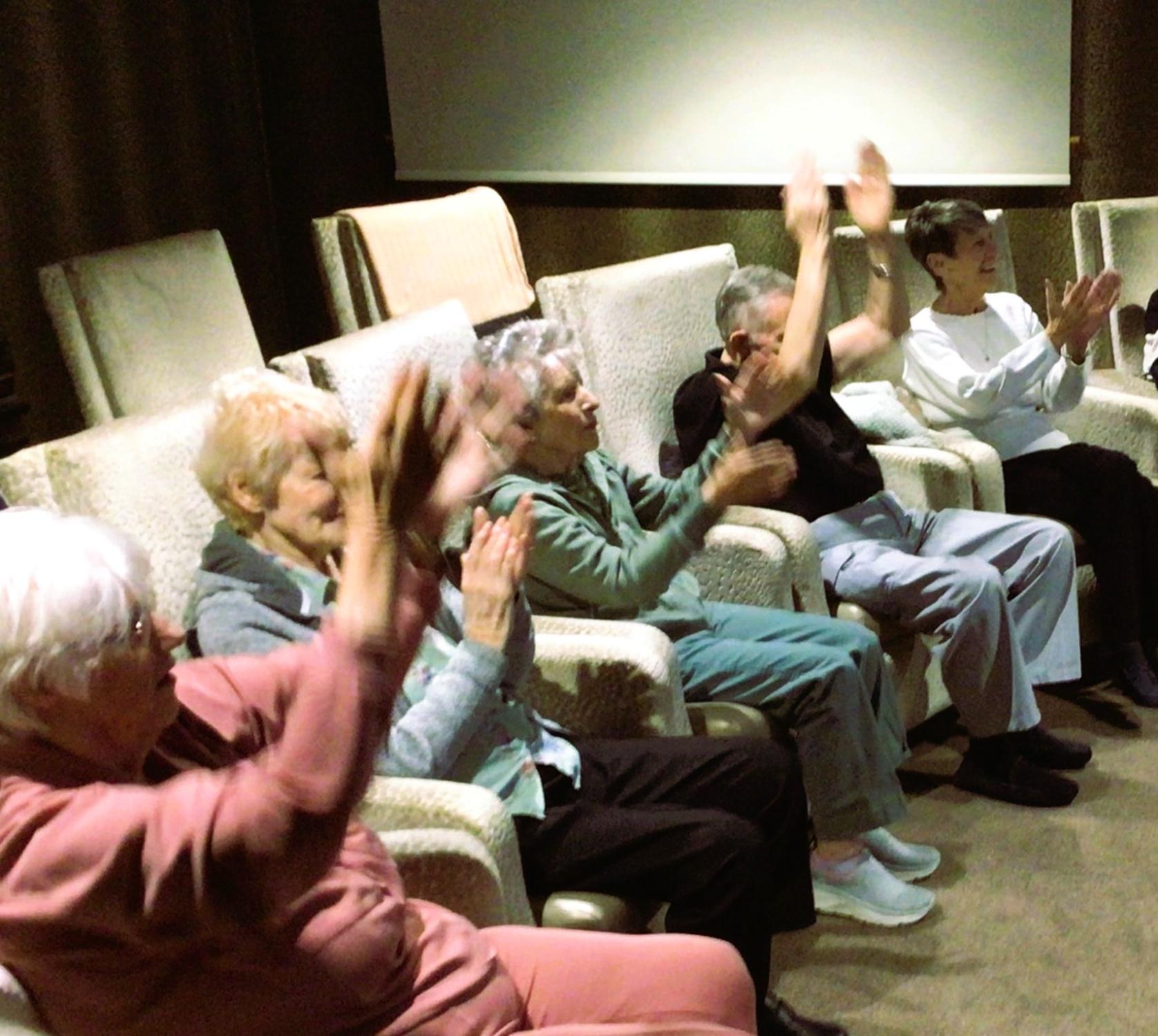 residents cheering in the cinema room