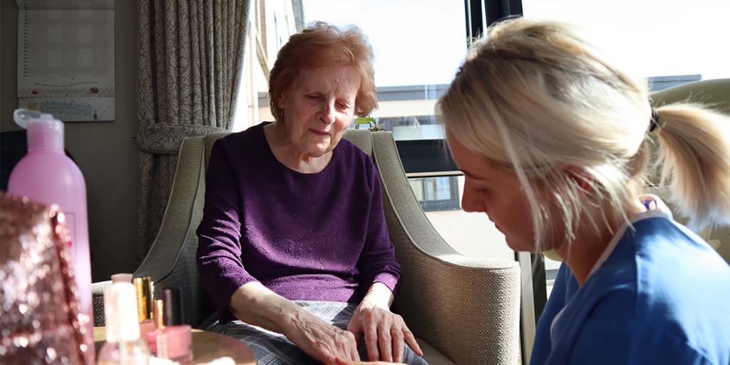 Resident and Staff in Nail Bar