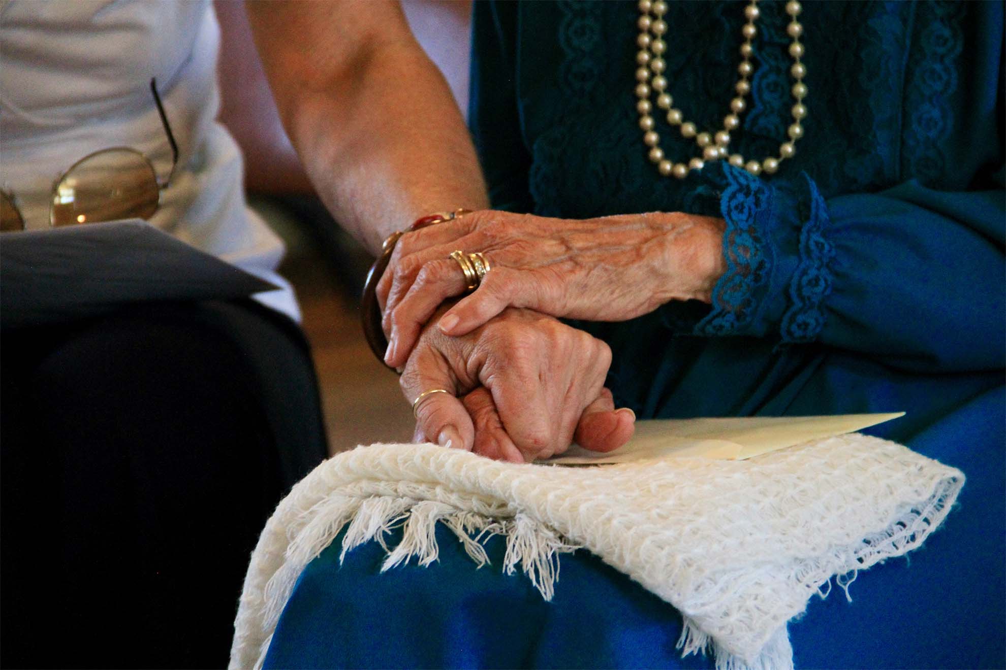 staff holding hands with resident in comfort