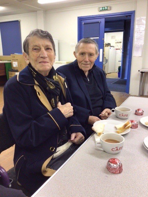 alex and jean smiling together over coffee