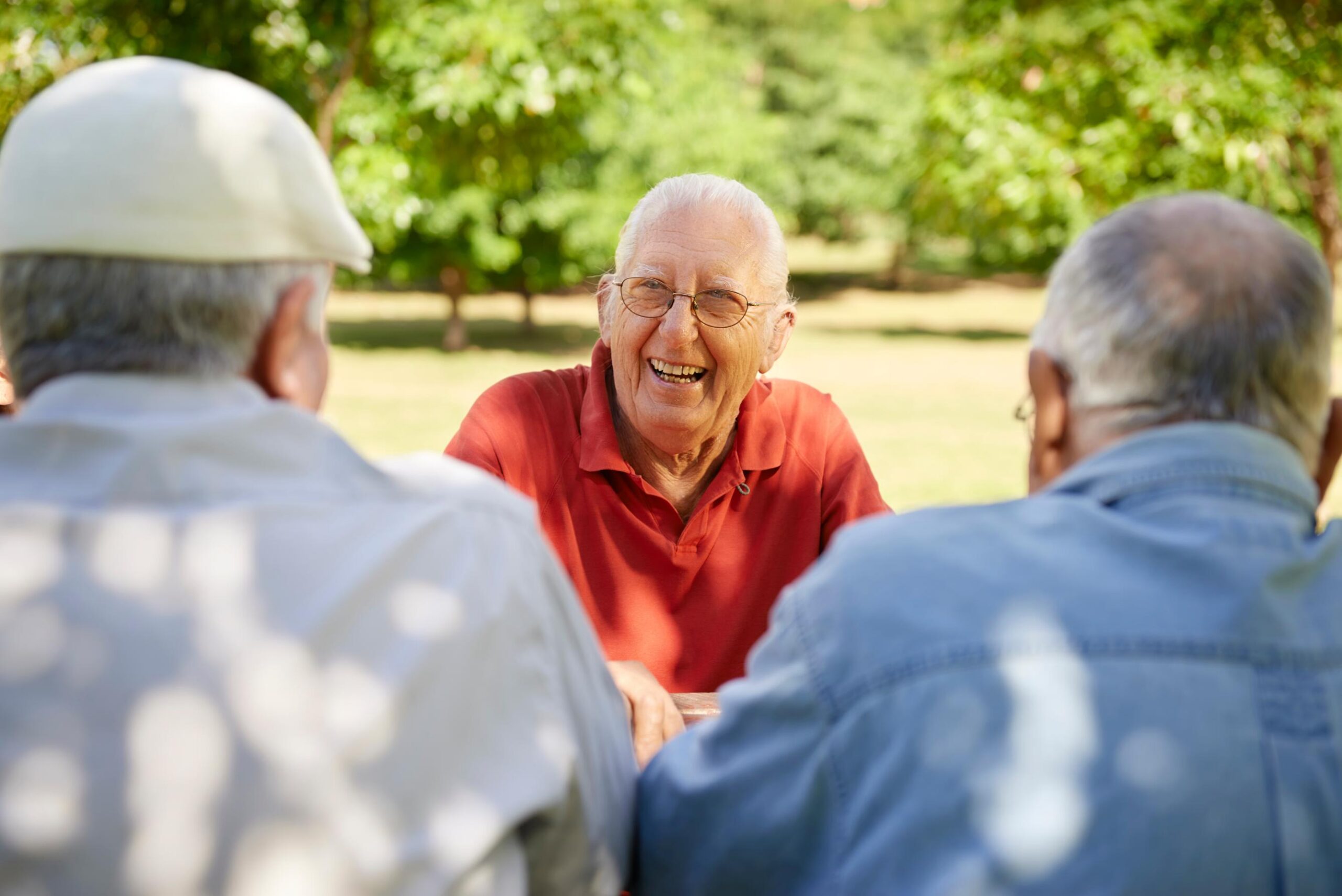 elderly men laughing together outdoors