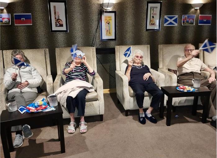 residents holding scottish flags