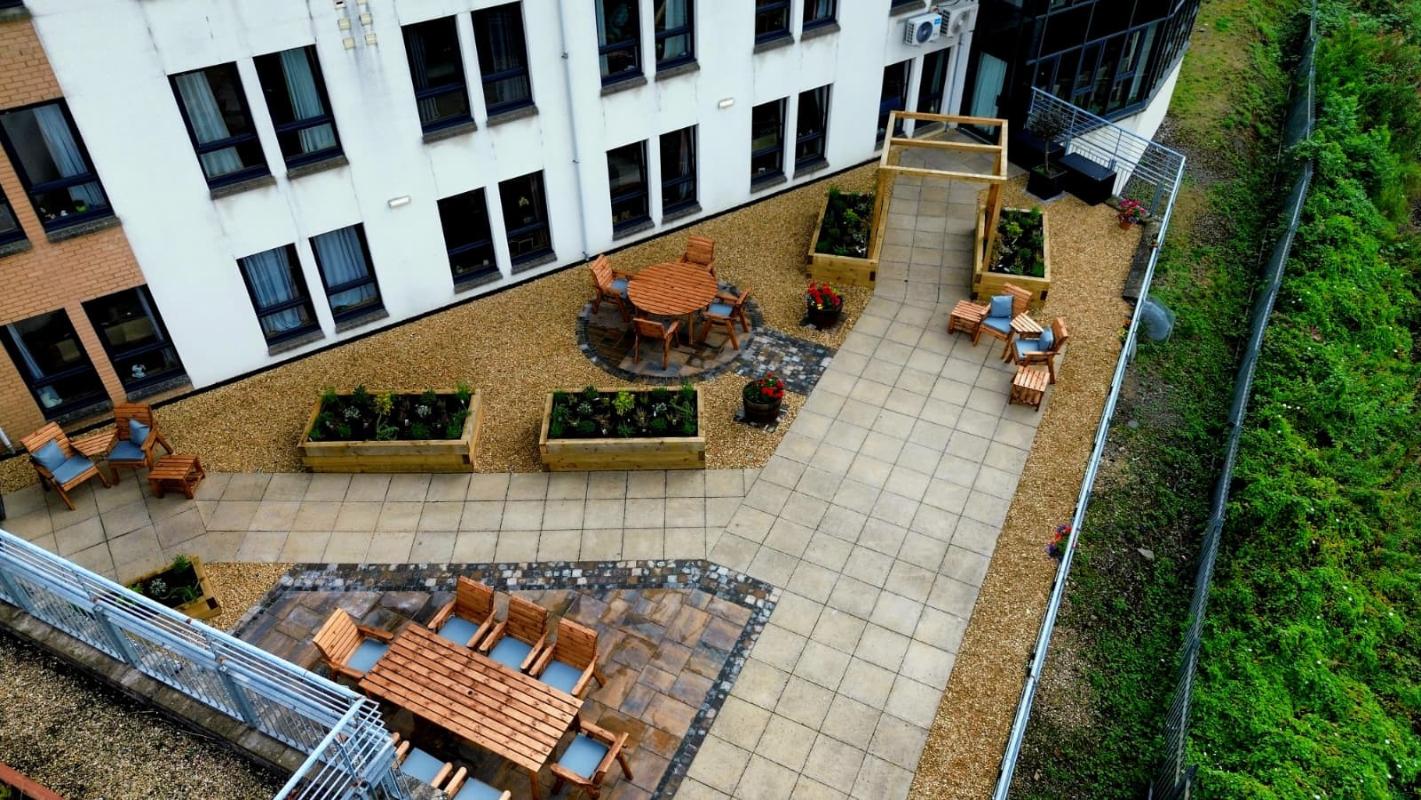 care home patio from above with benches and pergola