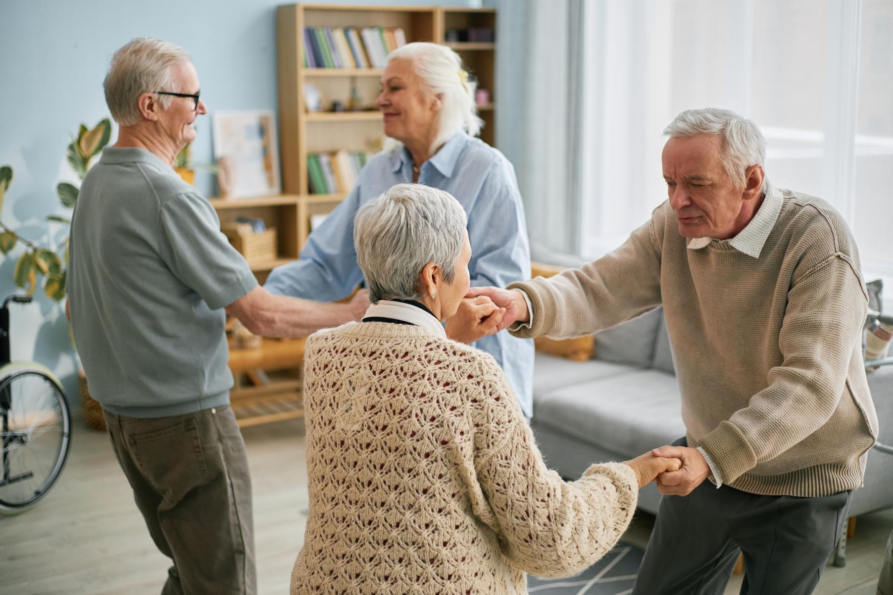 care home residents dancing together